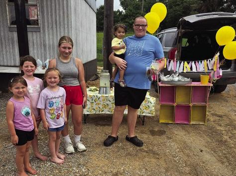 (LEFT to RIGHT) Emma Evans, Carolyne Barron, Jolie Taliaferro, Audrey Duck, and Kyle Watson (childhood cancer survivor). They raised $620 for St. Jude’s selling lemonade at Duck’s Barber Shop.