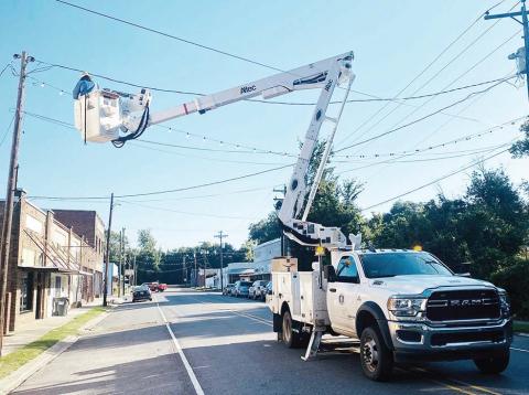 Warren Davis, with Town of Jonesville, installed bulbs on the light strands that line Mound and First Streets.