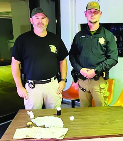 DEPUTY DEWAIN Littleton and Deputy Chris Ahmed pictured above with contraband from the arrest.