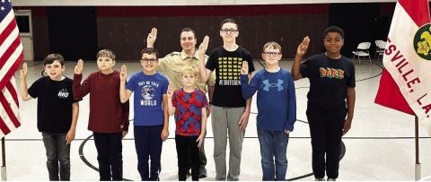 Scoutmaster Ronnie “Chip” Hill, Jr. (back) and the Scout Troop 21