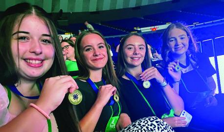 MADYSON CAMPBELL, Ainsley Ogle, Claire Campbell, and Emily Womack displaying their medals.