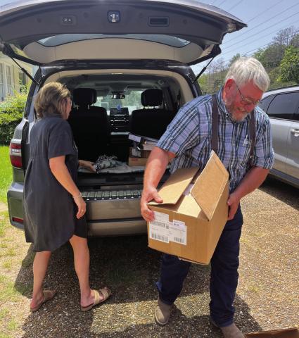 SCHOOL BOARD member, John Wayne Allbritton, helps HHS principal unload curriculum supports her vehicle.
