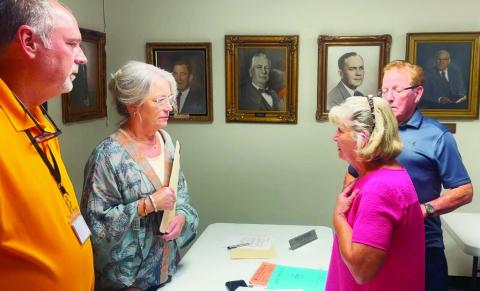 SUPERINTENDENT ADAMS, Board Member Cynthia Brown, Mrs. Nelda Mann, and Board Member Dewey Stockman discussing JES matters after meeting. (CNB photo)