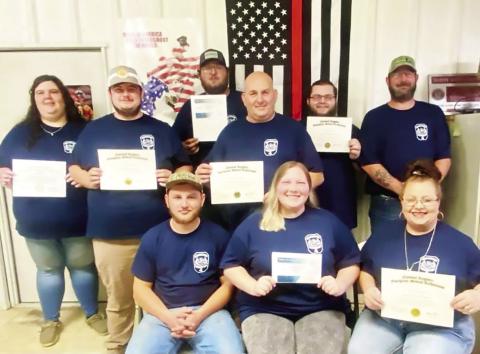 SLFD VOLUNTER fire fighters: (left to right seated) Board member Chase Powell, Tylin Powell (EMR), Michelle Squyres (NREMT), (middle row) Jacob Sean Littleton (NREMT), David Squyres (NREMT/Instructor ), (rear row): Sarah Murphy (NREMT/Instructor), Logan Littleton (EMR), George Cupstid (NREMT), and board member Chad Littleton.