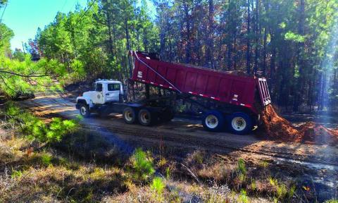 CATAHOULA PARISH Police Jury Barn employees pictured above repairing Old Columbia Road