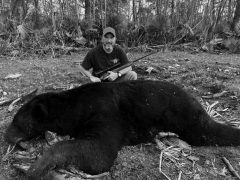 DERON SANTINY with the 696-pound Louisiana black bear he harvested in Tensas Parish pictured above.